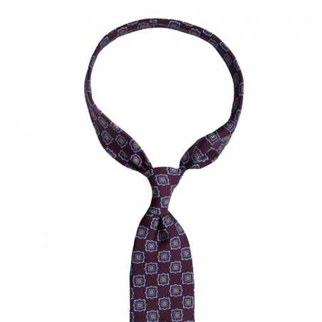 Burgundy silk tie with an ornamental pattern