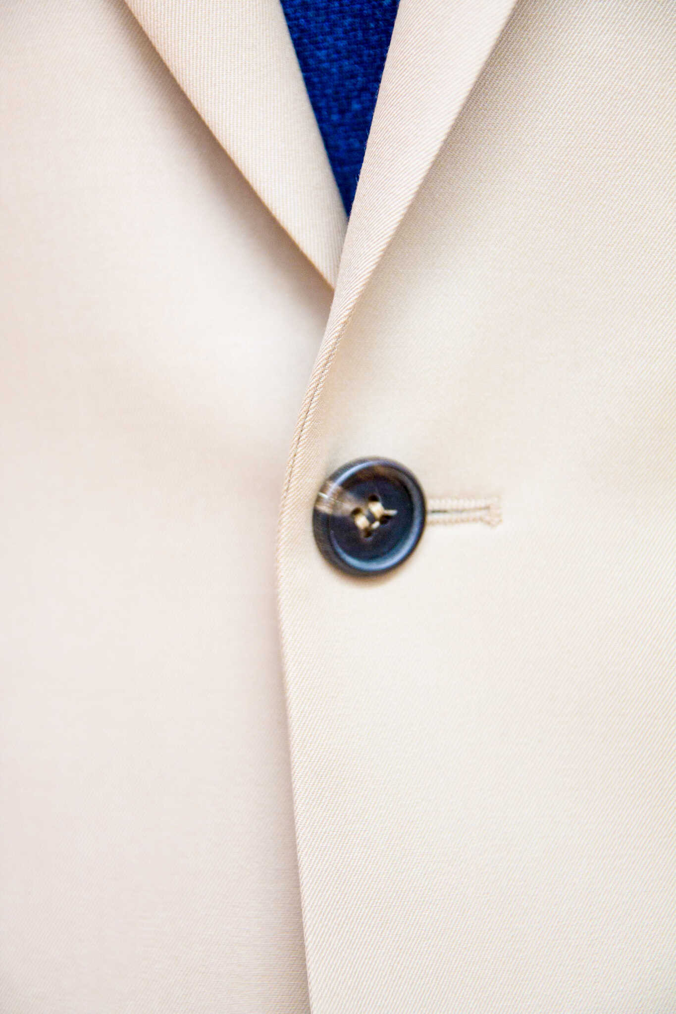 A single-breasted beige suit